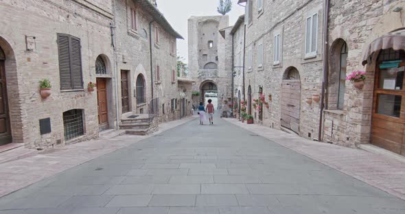 Romantic Couple Walking Visiting Rural Town of Assisi.Back follow.Friends Italian Trip in Umbria