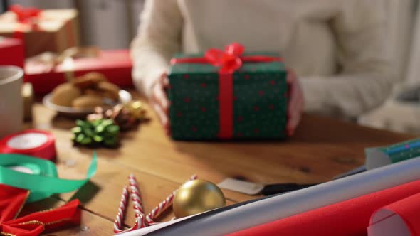 Woman Packing Christmas Gifts at Home