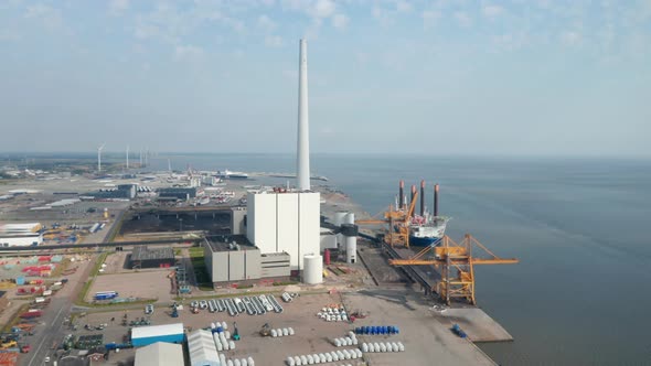 Aerial View Over the City of Esbjerg with Slow Rotation on Harbor and Tallest Chimney of Scandinavia