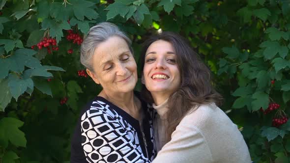 Happy Senior Mother in Eyeglasses is Hugging Her Adult Daughter the Women are Enjoying Together