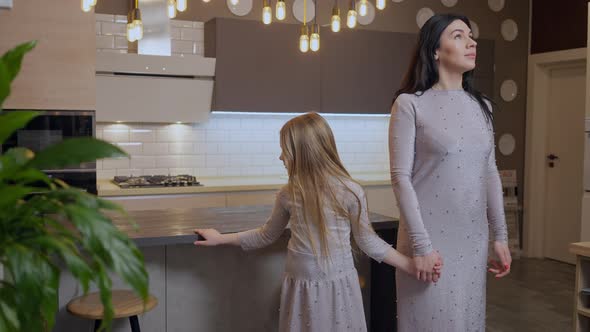 Beautiful Caucasian Mother and Pretty Daughter Admiring New Furniture in Shop Indoors