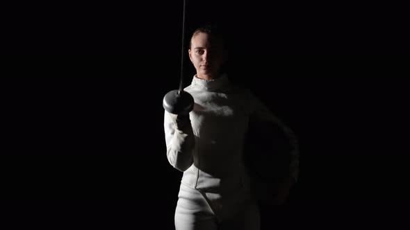 Portrait of a Young Woman Fencer Saluting with Rapier in Greeting