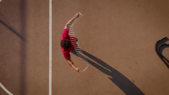 Aerial shot of a man working out with a jump-rope