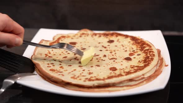 Pancakes on a Plate and Grease with Butter