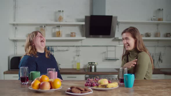 Joyful Deaf-mute Females Laughing in the Kitchen