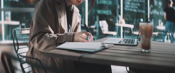 Young professional woman writes in a notebook