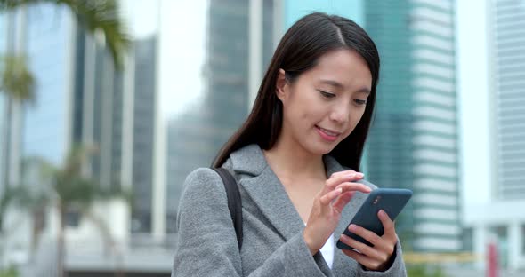 Business woman use of smart phone in city 