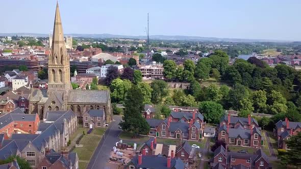 Aerial pan past an old church in Exeter, England