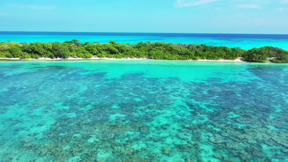 Natural flying clean view of a white sand paradise beach and turquoise sea background in colorful 4K