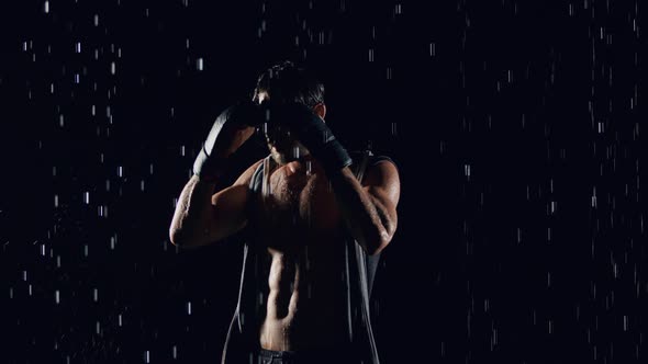 Athletic Man Boxing In The Rain
