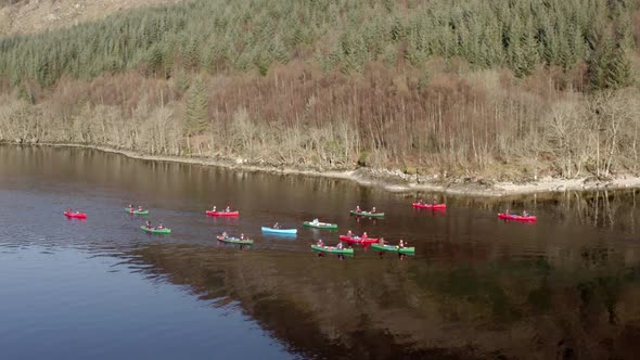 A Team of Canoeists Traversing a Lake in the Early Morning