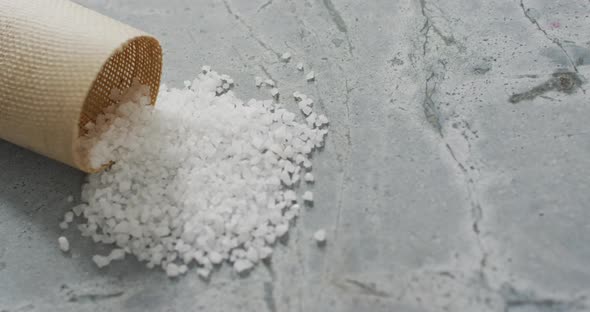 Video of pile of salt and cup on stone kitchen worktop