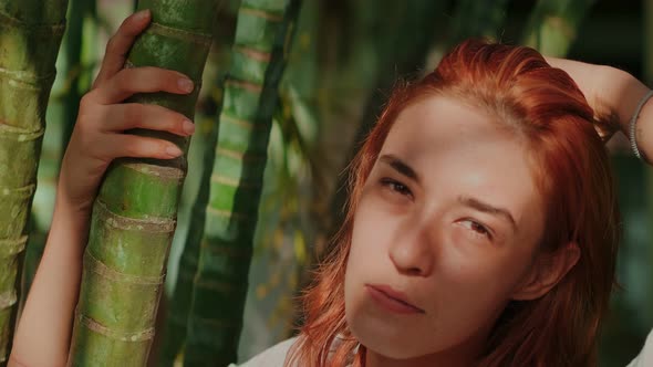 Young Redhead Woman Posing in the Bamboo Forest