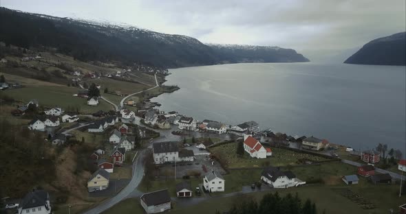 Aerial shot of Utvik village located on shore of Norwegian fjord