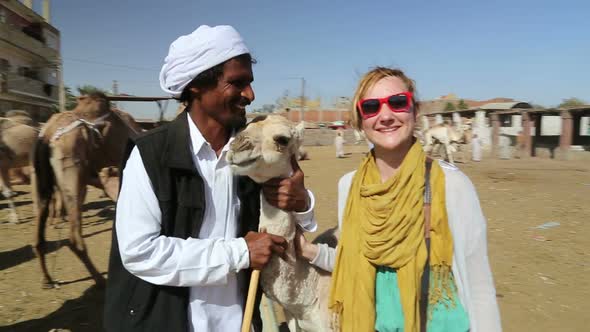 Female tourist with local man at Camel market
