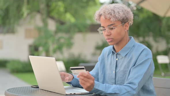 Successful Online Payment on Laptop By Young African Woman