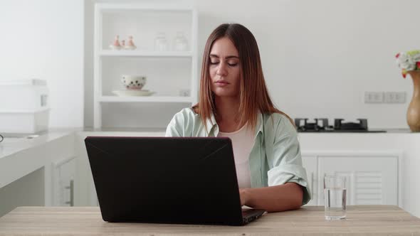 Young Woman Finishing Work on Laptop