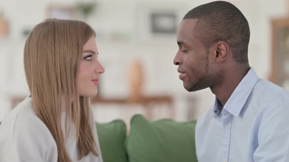 Mixed Race Couple Looking at Each Other Lovingly at Home