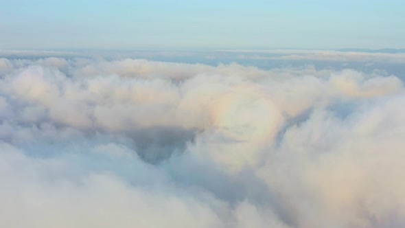 The Drone Rises From the Thick Fog Over the Beautiful Ocean of Clouds at Dawn