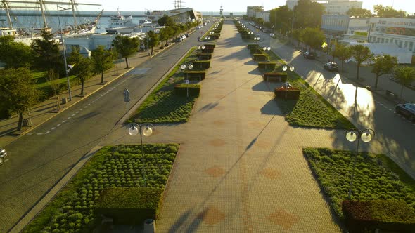 View Of The Promenade At The Pier Of Marina Gdynia In Poland On A Sunny Day - pullback drone shot