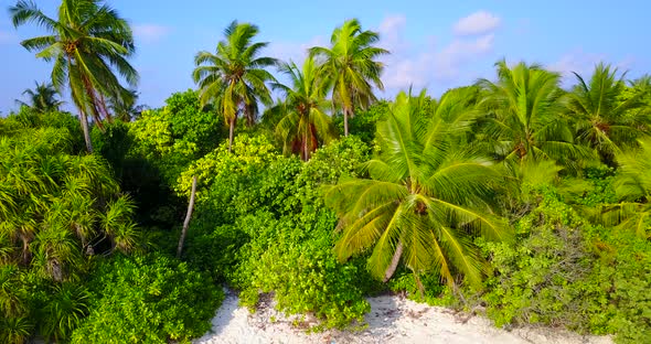 Beautiful fly over tourism shot of a sunshine white sandy paradise beach and aqua turquoise water ba