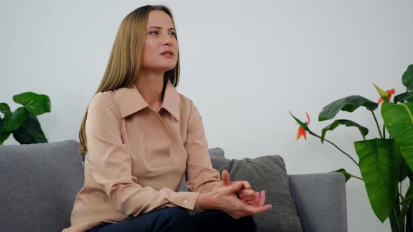 Adult Woman with Mental Health Problem Talking to Psychologist in Clinic