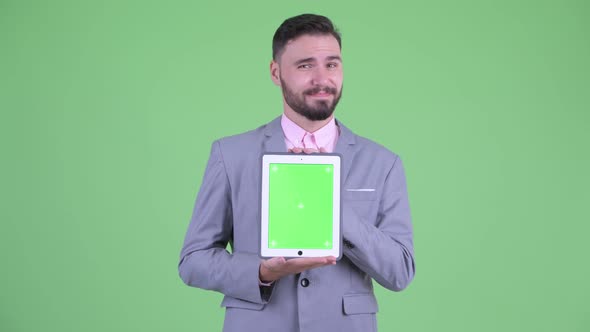 Stressed Young Bearded Businessman Showing Digital Tablet