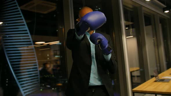 Young African American Boxer in Gloves and Formal Suit Posing and Waving with His Boxing Gloves