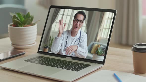 Close Up Video Call With Asian Doctor On Laptop Computer