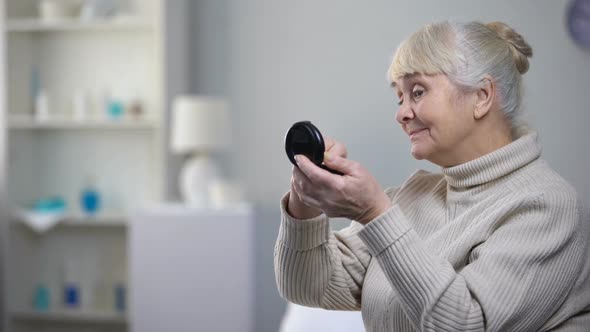 Elegant Old Woman Applying Skin Powder and Refusing Medical Pills, Nursing Home