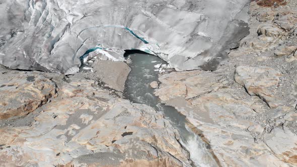 Aerial: glacier melting and receding, global warming melting ice sheet