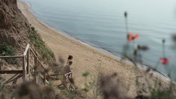 Relaxed Lovers Watching Amazing Seascape Standing Beach Stairway in Distance