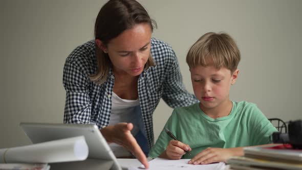 Mother and 8 Year Old Son Doing Homework
