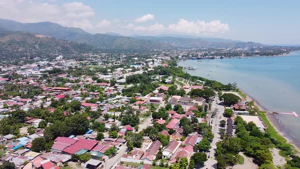Aerial drone of capital city Dili in Timor Leste, South East Asia, high up and lowering towards buil