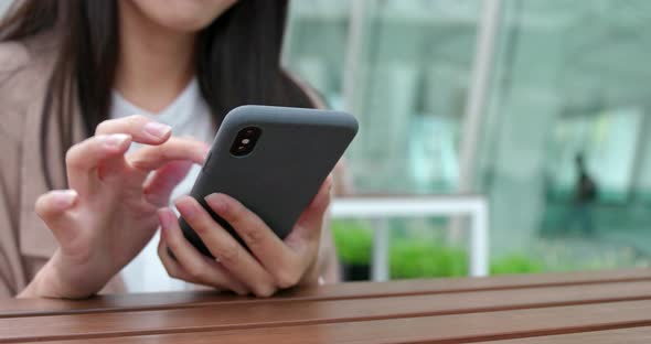 Woman use of mobile phone at outdoor coffee shop