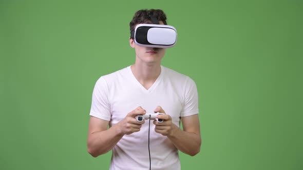 Young Handsome Man Playing Games While Using Virtual Reality Headset