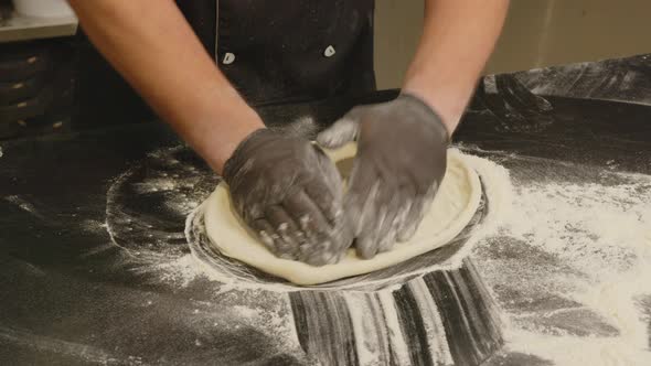 Senior Professional Italian Restaurant Chef Working Shaping Floured Dough for Pizza