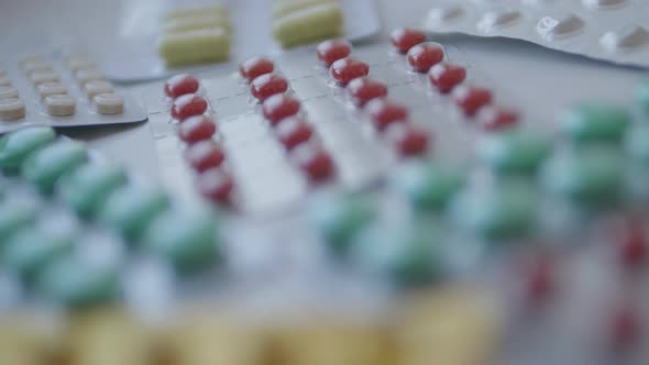 Toddler Sits on Windowsill and Plays with Scattering Pills Without Parent's Control. Dangerous