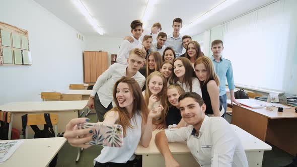 Young Happy Cheerful Students Making Selfie in School Class