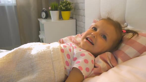 Little Girl in the Bedroom at Home