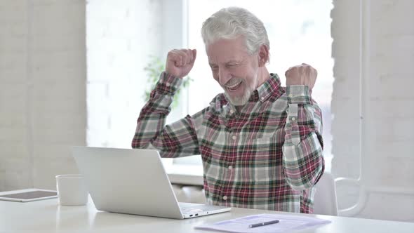 Casual Old Man Celebrating Success on Laptop