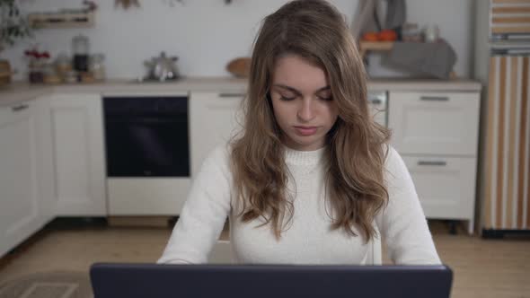 Young Happy Woman Working on Laptop at Home