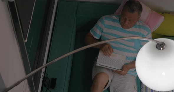 Man with Netbook Resting on the Couch