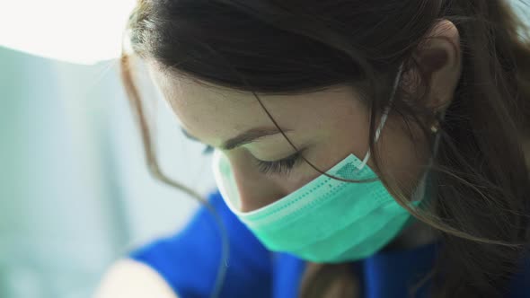 Woman with Green Mask Pops Pimples on Client Face in Clinic