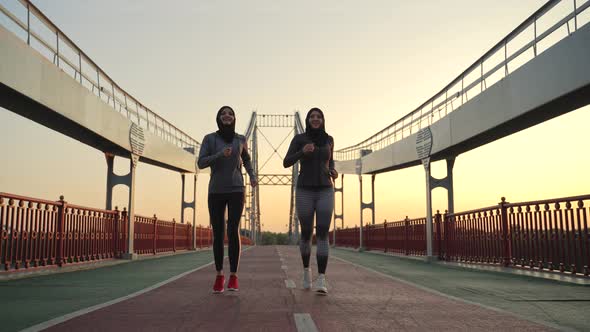 Active Muslim Females in Hijabs Jogging at Dawn