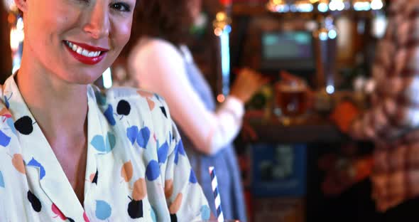 Portrait of beautiful woman with hurricane cocktail