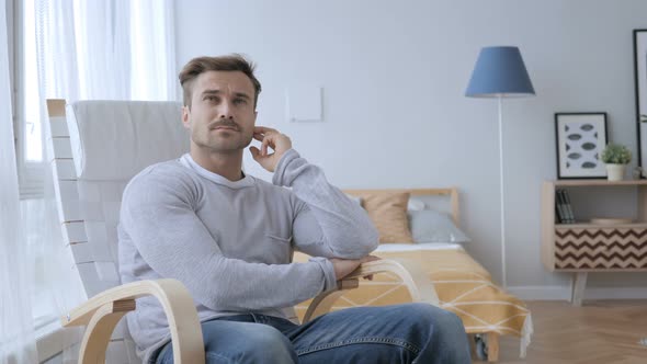 Thinking Middle Aged Man Sitting on Casual Chair, Brainstorming