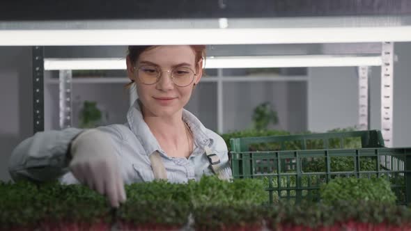 Small Business Charming Businesswoman Collects a Sales Order for a Customer and Puts a Micro Green