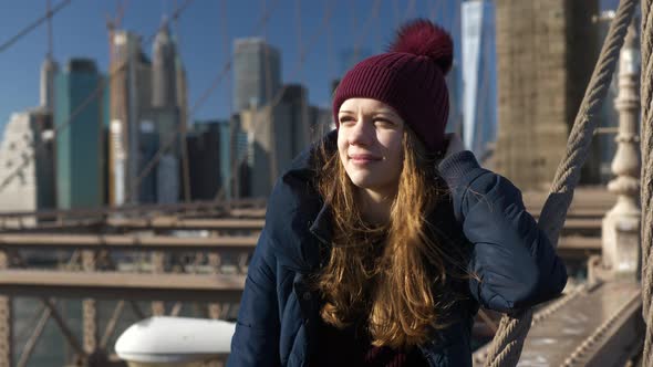 Beautiful Girl on Brooklyn Bridge Enjoys a Sunny Day While Relaxing