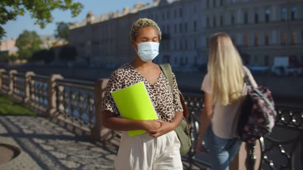 African Female Student with Protective Mask Walking in City Street.